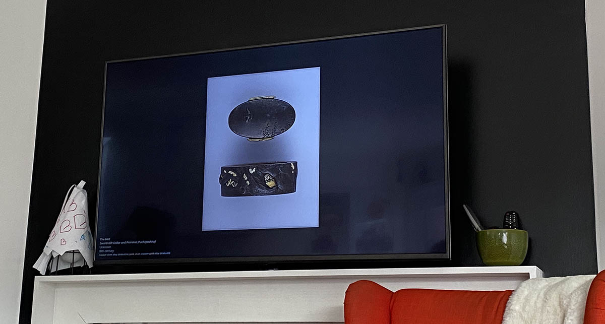 A Japanese sword hilt and collar on the screen from The Met collection.