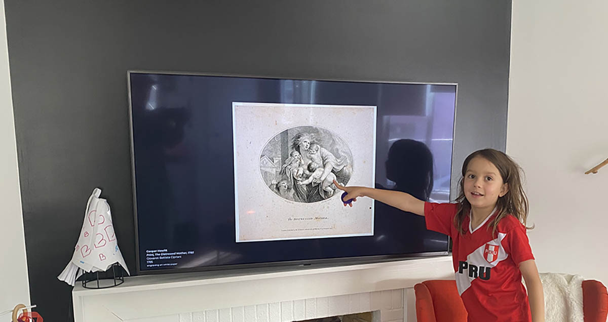 Kid touching artwork on a screen